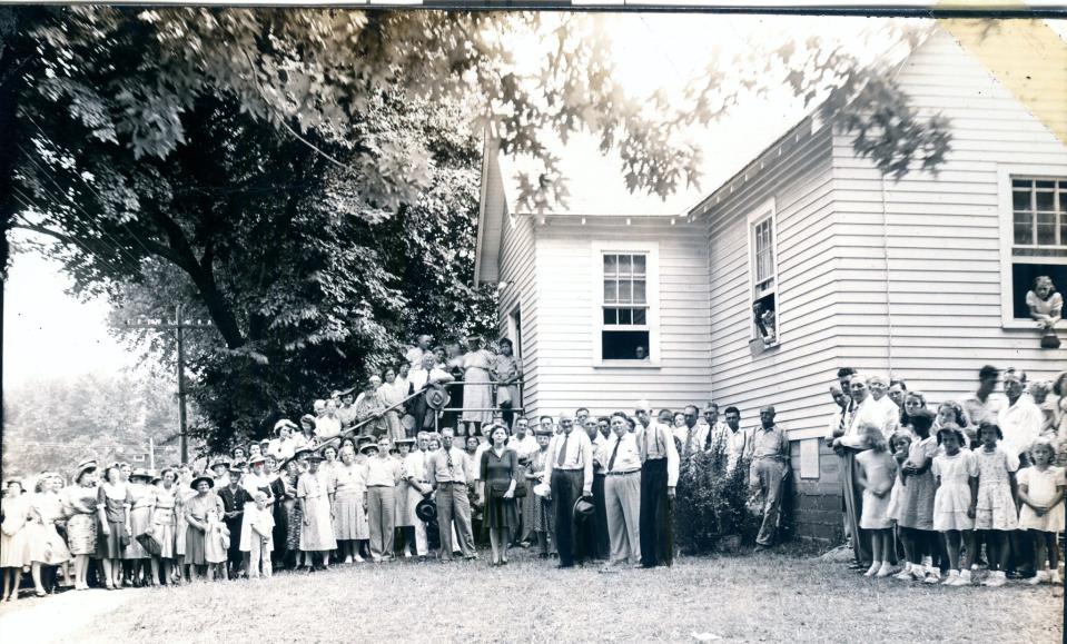 The old Harmony Baptist Church congregation and church, which once sat on the southwest corner of US Route 60 and Missouri State Highway 125. The church was moved about a mile south on Highway 125 when US 60 was made into a four-lane highway.  the 1960s.