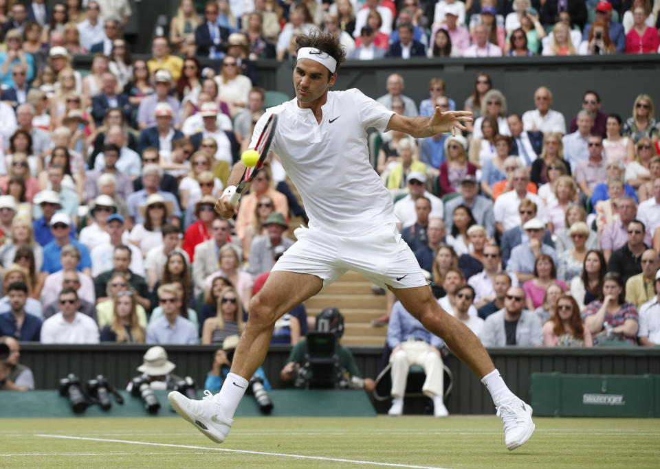 Roger Federer of Switzerland plays a return to Novak Djokovic of Serbia during the men's singles final at the All England Lawn Tennis Championships in Wimbledon, London, Sunday July 12, 2015. (AP Photo/Alastair Grant)