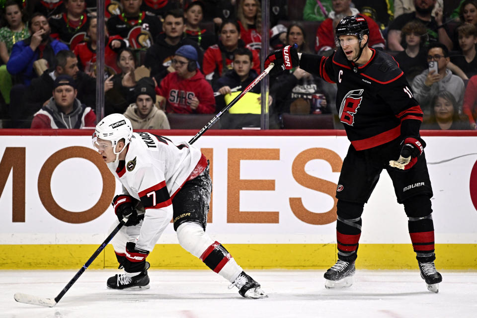 Carolina Hurricanes center Jordan Staal (11) reacts as his stick is caught under Ottawa Senators left wing Brady Tkachuk (7) as he picks himself off the ice during the second period of an NHL hockey game in Ottawa, Ontario, on Sunday, March 17, 2024. (Justin Tang/The Canadian Press via AP)