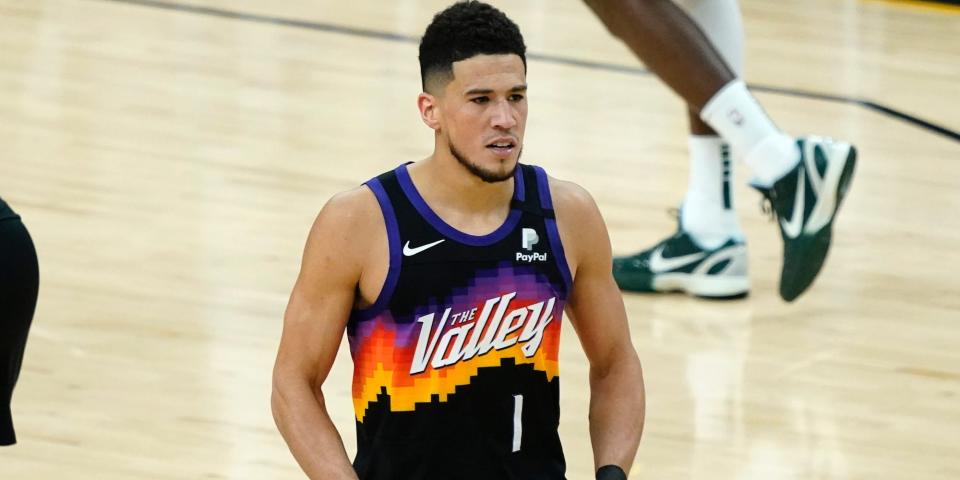 Devin Booker flexes during Game 1 of the Finals.