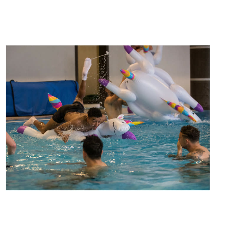 Kieran Trippier, Jordan Pickford, Jesse Lingard and Harry Maguire play with inflatable unicorns in the pool during a recovery session at the ForRestMix Hotel in Repino