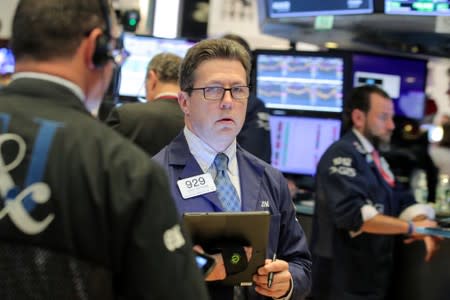 Traders work on the floor at the NYSE in New York