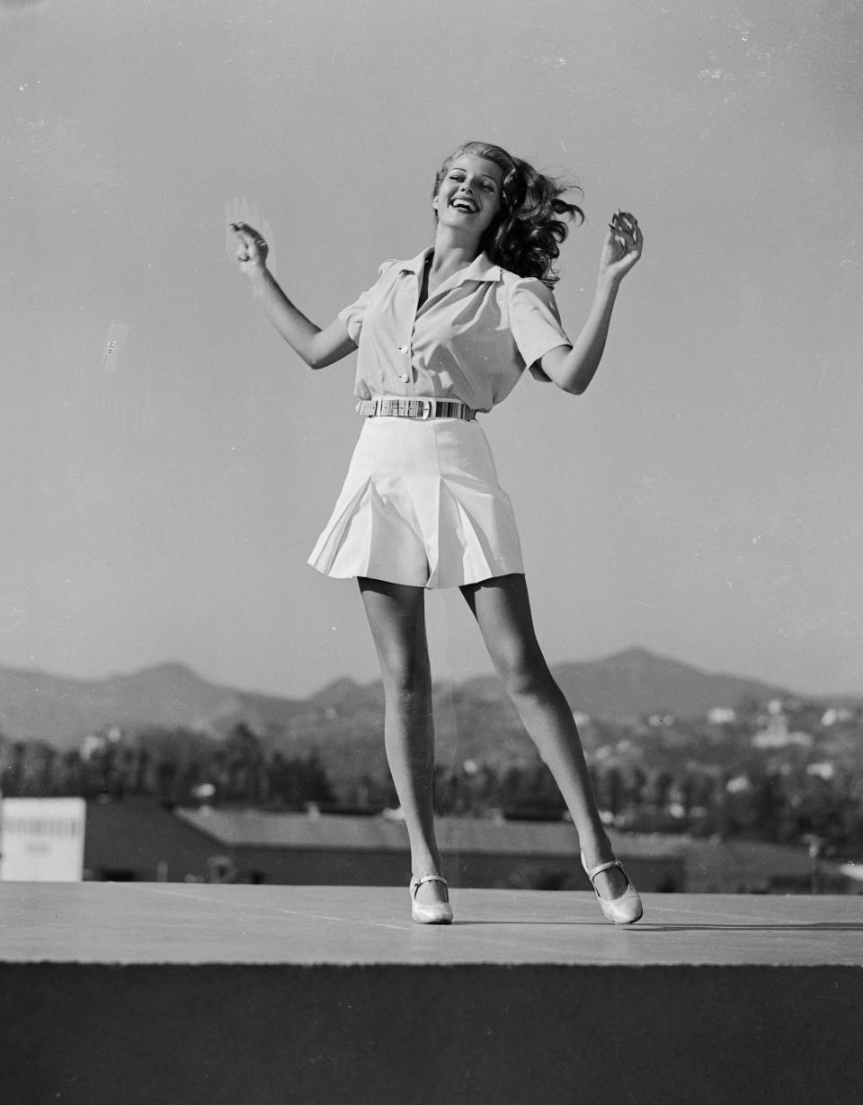Hayworth's pleated shorts and button-up are the epitome of summer chic. Here, she was photographed in 1941.&nbsp;