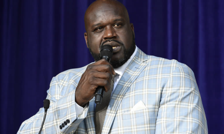 Shaq speaking into a microphone.