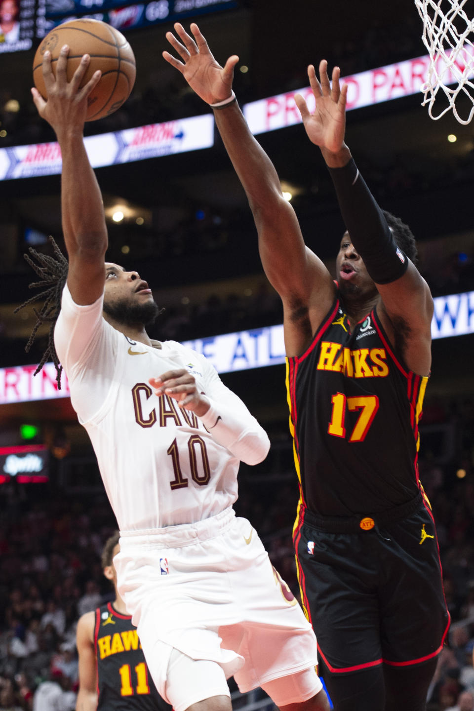 Cleveland Cavaliers guard Darius Garland scores against Atlanta Hawks forward Onyeka Okongwu during the second half of an NBA basketball game Tuesday, March 28, 2023, in Atlanta. (AP Photo/Hakim Wright Sr.)