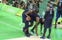 2016 Rio Olympics - Basketball - Semifinal - Men's Semifinal Spain v USA - Carioca Arena 1 - Rio de Janeiro, Brazil - 19/8/2016. Deandre Jordan (USA) of the USA is aided after being fouled. REUTERS/Mariana Bazo