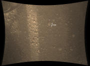 IN SPACE - AUGUST 8: In this handout image provided by NASA and released on August 8, 2012, a full-resolution color image from NASA's Curiosity Rover shows the pebble-covered surface of Mars. It was taken by the Mars Descent Imager (MARDI) several minutes after Curiosity touched down. The camera is about 30 inches (70 centimeters) from the surface as the rover sits on the ground. The image pixel scale is about 0.02 inches (0.5 millimeters), but the camera is slightly out of focus at this distance, so the actual ground scale is about 0.06 inches (1.5 millimeters). A sliver of sunlight passing through the structure of the rover illuminates the surface. The largest rock fragment in the image is about 2 inches (5 centimeters) long. Most are much smaller. A rover wheel is visible at the top left. (Photo by NASA/JPL-Caltech/MSSS via Getty Images)