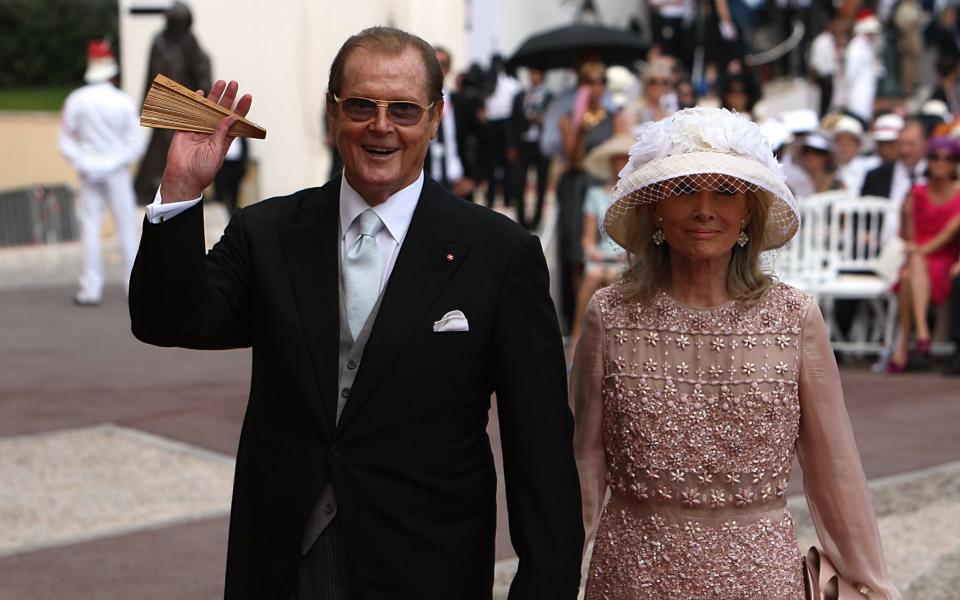 Sir Roger Moore and wife Kristina arriving for the wedding of Prince Albert II of Monaco and Charlene Wittstock at the Place du Palais. - Credit: Dominic Lipinski/PA Wire