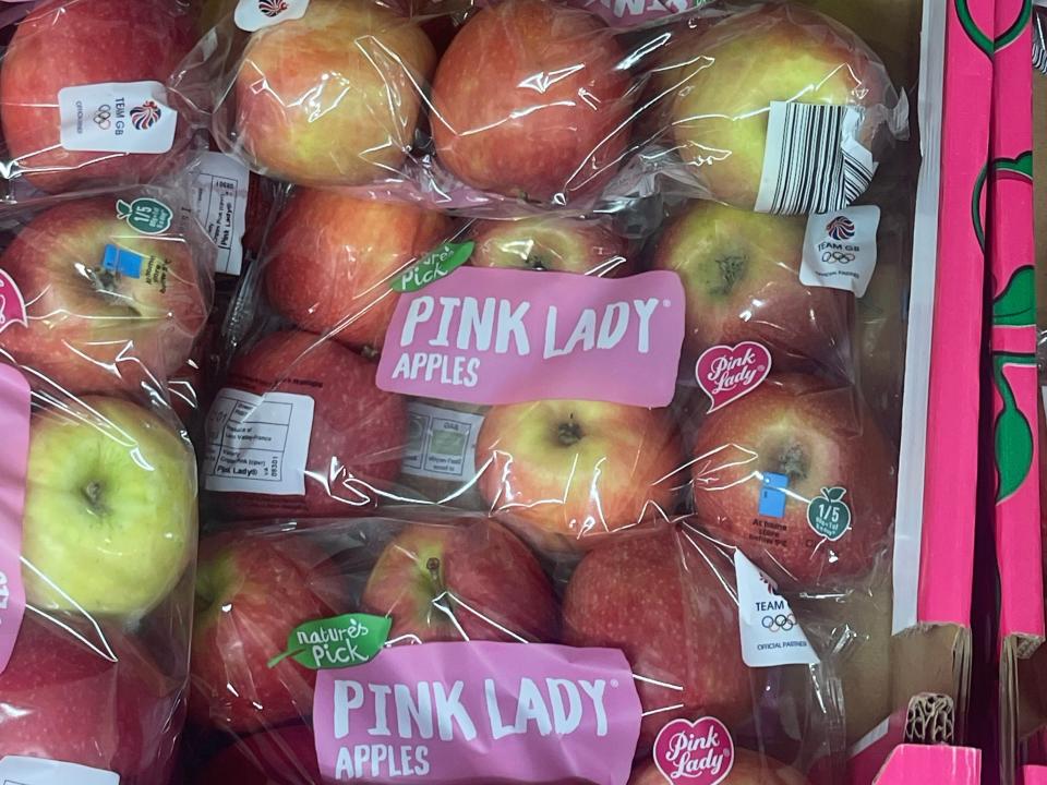 bags of apples in the produce section at aldi