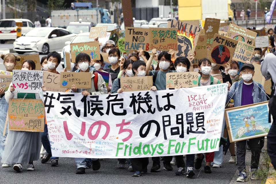 Climate activists attend a demonstration in Tokyo, Friday, Sept. 23, 2022. Youth activists staged a coordinated “global climate strike” on Friday to highlight their fears about the effects of global warming and demand more aid for poor countries hit by wild weather. The banner, front, reads "Climate crisis is a life issue." (Kyodo News via AP)