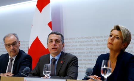 Swiss Economic Minister Parmelin and Swiss Justice Minister Keller-Sutter sit beside as Swiss Foreign Minister Cassis addresses a news conference in Bern