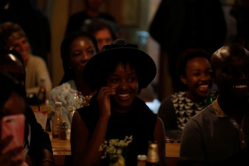 A woman in the audience laughs during a standup show by Kenyan comedian Brian Onjoro at the Kez's Kitchen restaurant in Nairobi