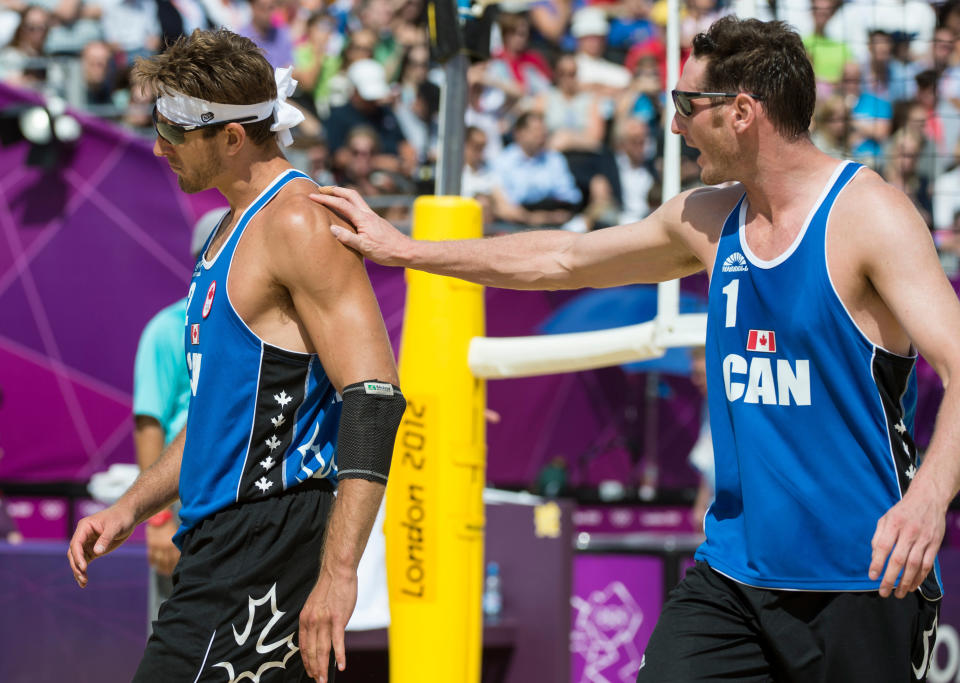 Canada's Joshua Binstock talks to partner Martin Reader during preliminary beach volleyball action against Tarjei Viken Skarlund and Martin Spinnangr at the 2012 London Olympic Games, on July 30, 2012. Binstock and Reader lost two sets to none. COC Photo: Jason Ransom