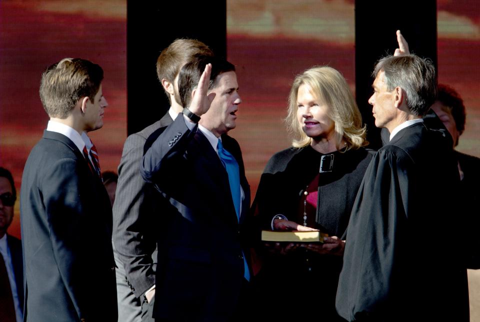 Gov. Doug Ducey is sworn in by Arizona Supreme Court Chief Justice Scott Bales on Jan. 7, 2019, at the state Capitol in Phoenix.