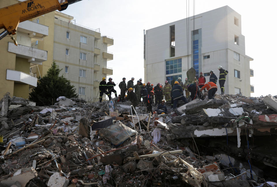 Emergency personnel work on debris of a collapsed building in the town of Durres, following Tuesday's powerful earthquake that shook Albania, November 27, 2019. REUTERS/Florion Goga