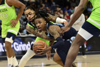 Memphis Grizzlies guard Ja Morant handles the ball against Minnesota Timberwolves guard D'Angelo Russell in the second half of an NBA basketball game Monday, Nov. 8, 2021, in Memphis, Tenn. (AP Photo/Brandon Dill)