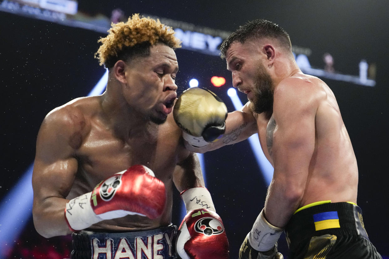 Devin Haney, left, fights Vasiliy Lomachenko in an undisputed lightweight championship boxing match Saturday, May 20, 2023, in Las Vegas. Haney won by unanimous decision. (AP Photo/John Locher)