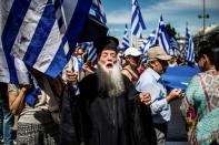 A Greek Orthodox priest takes part in a demonstration in Athens on June 15 against the agreement reached to resolve a 27-year name row with Macedonia