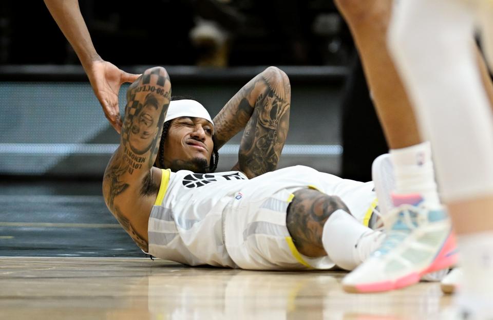 Utah Jazz guard Jordan Clarkson (00) rubs his head after hitting it on the floor as the Utah Jazz and Los Angeles Lakers play at the Delta Center in Salt Lake City on Saturday, Jan. 13, 2024. Utah won 132-125. | Scott G Winterton, Deseret News