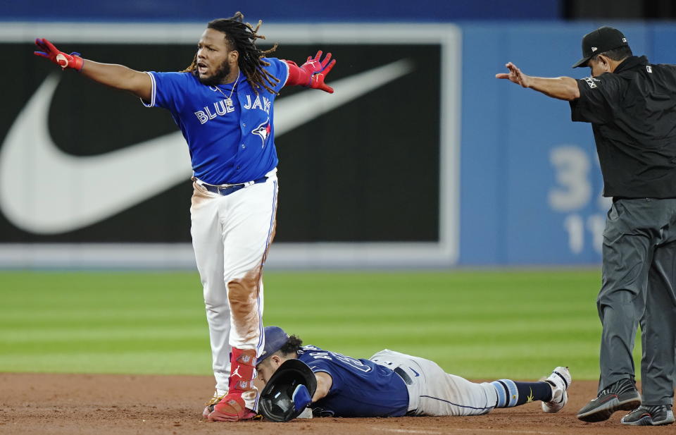 Toronto Blue Jays' Vladimir Guerrero Jr., left, celebrates his double next to Tampa Bay Rays second baseman Jonathan Aranda during the sixth inning of the second baseball game of a doubleheader Tuesday, Sept. 13, 2022, in Toronto. (Frank Gunn/The Canadian Press via AP)