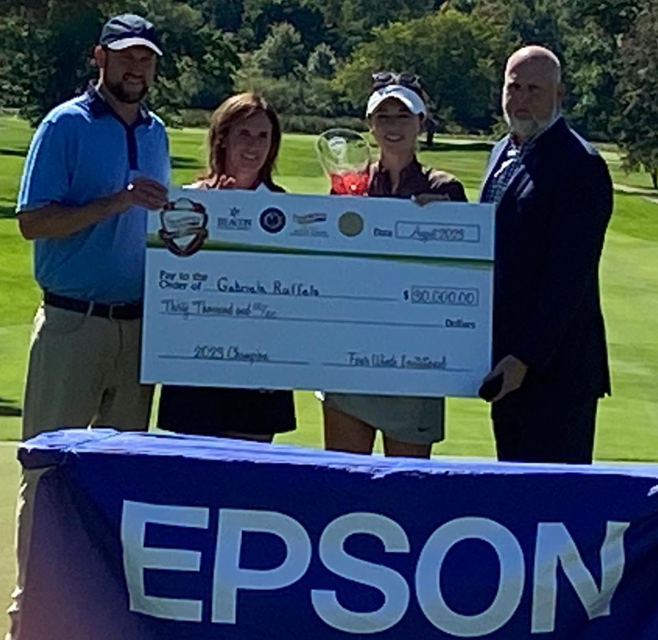 Australia's Gabriela Ruffels, second from right, receives the winner's check of $30,000 Saturday at South Bend Country Club following the conclusion of the Epson Tour's $200,000 Four Lakes Invitational. Ruffels shot a final round of three-under 69 for a three-round total of 12-under 204 and a three-stroke victory. Helping make the check presentation are, from left, golf professional and general manager Greg Helmkamp, Beacon Health Foundation president Susan King, and Scott Brewer, the senior vice president of government affairs at Four Winds Casinos.