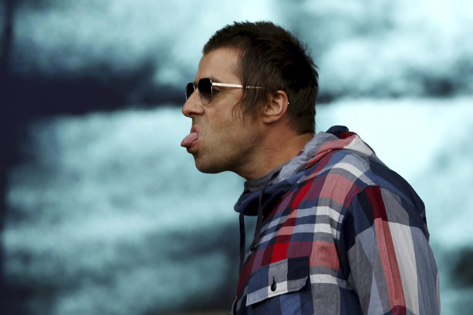 Musician Liam Gallagher pokes out his tongue as he performs on the Pyramid Stage on the fourth day of the Glastonbury Festival at Worthy Farm, Somerset, England, Saturday, June 29, 2019. (Photo by Grant Pollard/Invision/AP)