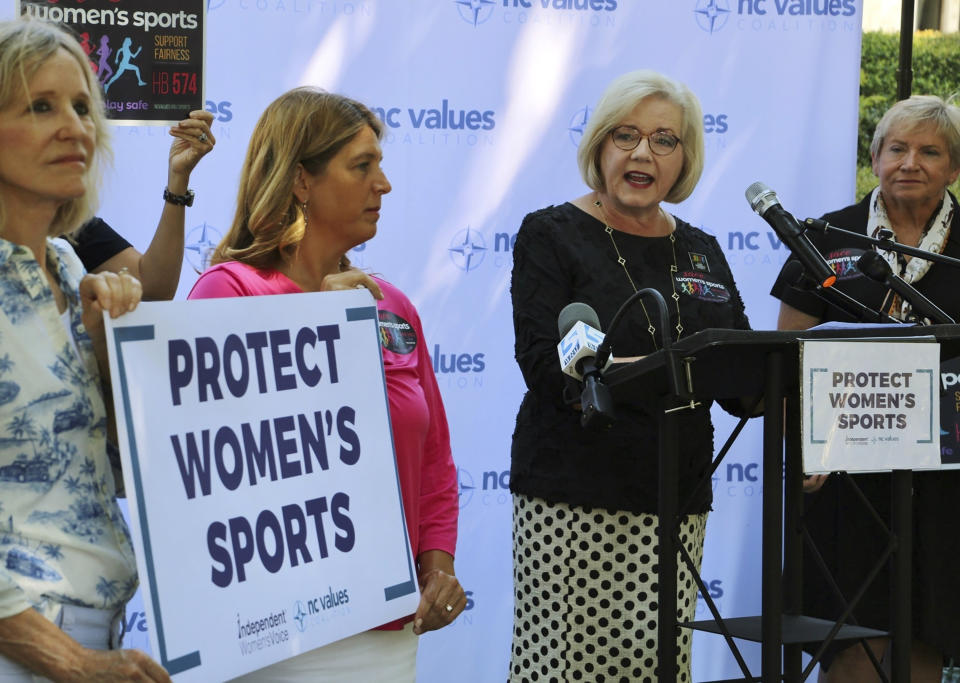 Tami Fitzgerald, center, the executive director of the conservative North Carolina Values Coalition, advocates for a bill banning transgender girls from competing in girls' school sports, Wednesday, Aug. 16, 2023, outside the Legislative Building in Raleigh, N.C. Republican state lawmakers will attempt later Wednesday to override the Democratic governor's veto of the legislation. (AP Photo/Hannah Schoenbaum)