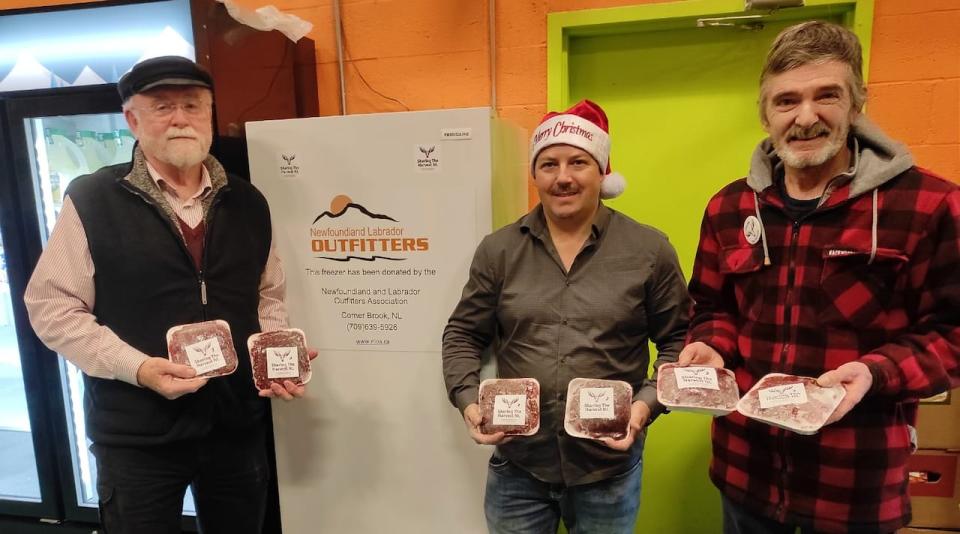 From the left: Nick Kelly, Corey Foster and Barry Fordham. A partnership between the Newfoundland and Labrador Outfitters Association and Sharing The Harvest NL brought in a new freezer for the Single Parent Association's food bank.