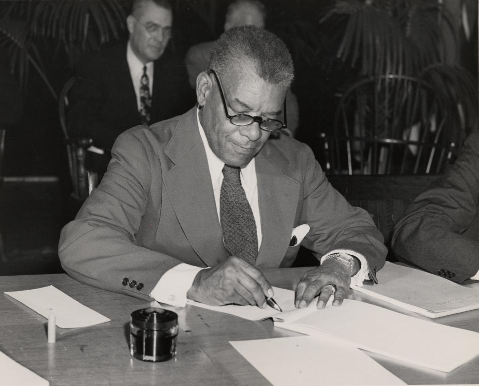 Oliver Randolph, the sole Black delegate to New Jersey's 1947 Constitutional Convention, reviews documents during the proceedings.