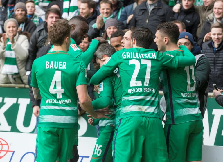 Werder Bremen's players react after scoring the first goal during the German First division Bundesliga football match March 18, 2017
