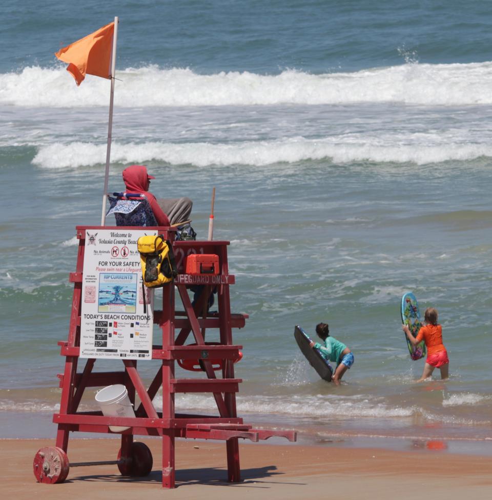 A lifeguard keeps a watchful eye on swimmers at Andy Romano Beachfront Park in Ormond Beach on Wednesday, April 24, 2024.