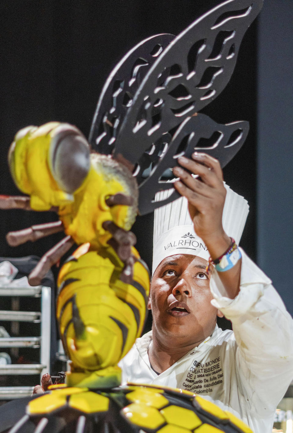 Carlos De Avila, of Colombia, adds a wing to a bee display during the Coupe de Monde de la Patisserie, or World Pastry Cup, at the Ernest N. Morial Convention Center in New Orleans, Tuesday, June 11, 2024. (Matthew Perschall/The Times-Picayune/The New Orleans Advocate via AP)