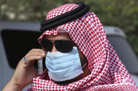 A man with mask speaks on his mobile phone in Jeddah May 29, 2014. Saudi Arabia is working with international scientific organisations to improve its response to a deadly new virus that has killed 186 people in the kingdom, its acting health minister Adel Fakieh told Reuters on Wednesday. REUTERS/Mohamed Alhwaity