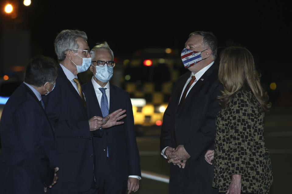 U.S. Secretary of State Mike Pompeo, second right, is welcomed by U.S. Ambassador to Greece Geoffrey Pyatt, second left, in the northern city of Thessaloniki, Greece, Monday, Sept. 28, 2020. Secretary Pompeo is on a two-day visit to Greece during which he will meet Greek Prime Minister Kyriakos Mitsotakis and Foreign Minister Nikos Dendias, and he will visit the Naval Support Activity base of Souda on the island of Crete. (AP Photo/Giannis Papanikos, Pool)