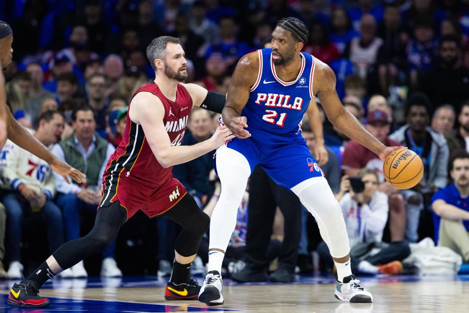 Philadelphia 76ers center Joel Embiid (21) controls the ball against Miami Heat forward Kevin Love (42) during the first quarter of a play-in game of the 2024 NBA playoffs at Wells Fargo Center on April 17, 2024.