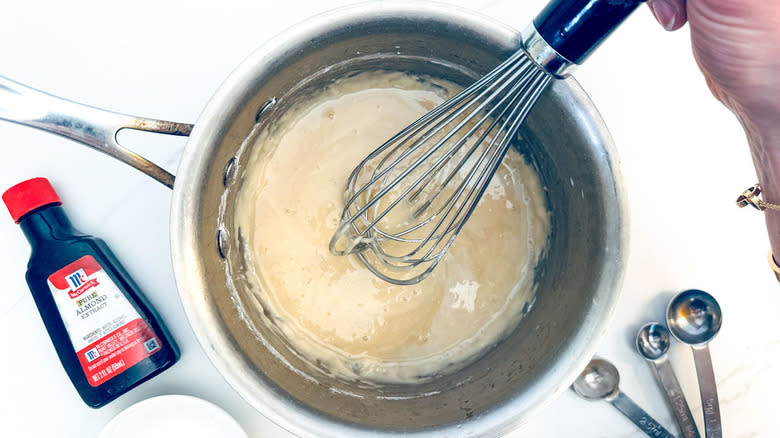 hand whisking ingredients in bowl