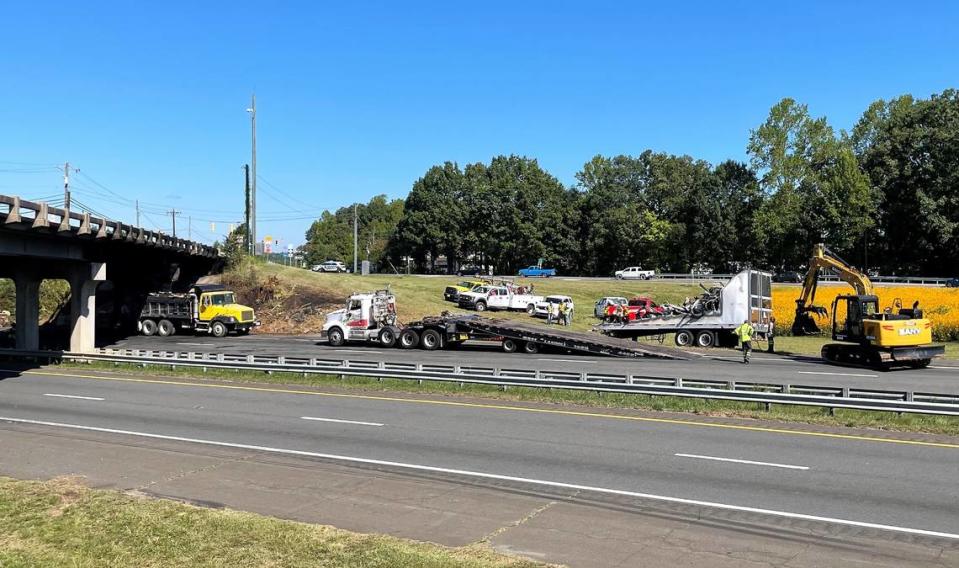 N.C. Highway Patrol, Orange County Sheriff’s Office and Hillsborough Police were helping to direct traffic Wednesday morning, Aug. 14, 2022, at Interstate 85 and NC 86 in Hillsborough as the remains of a tractor-trailer were being loaded onto a truck for removal.