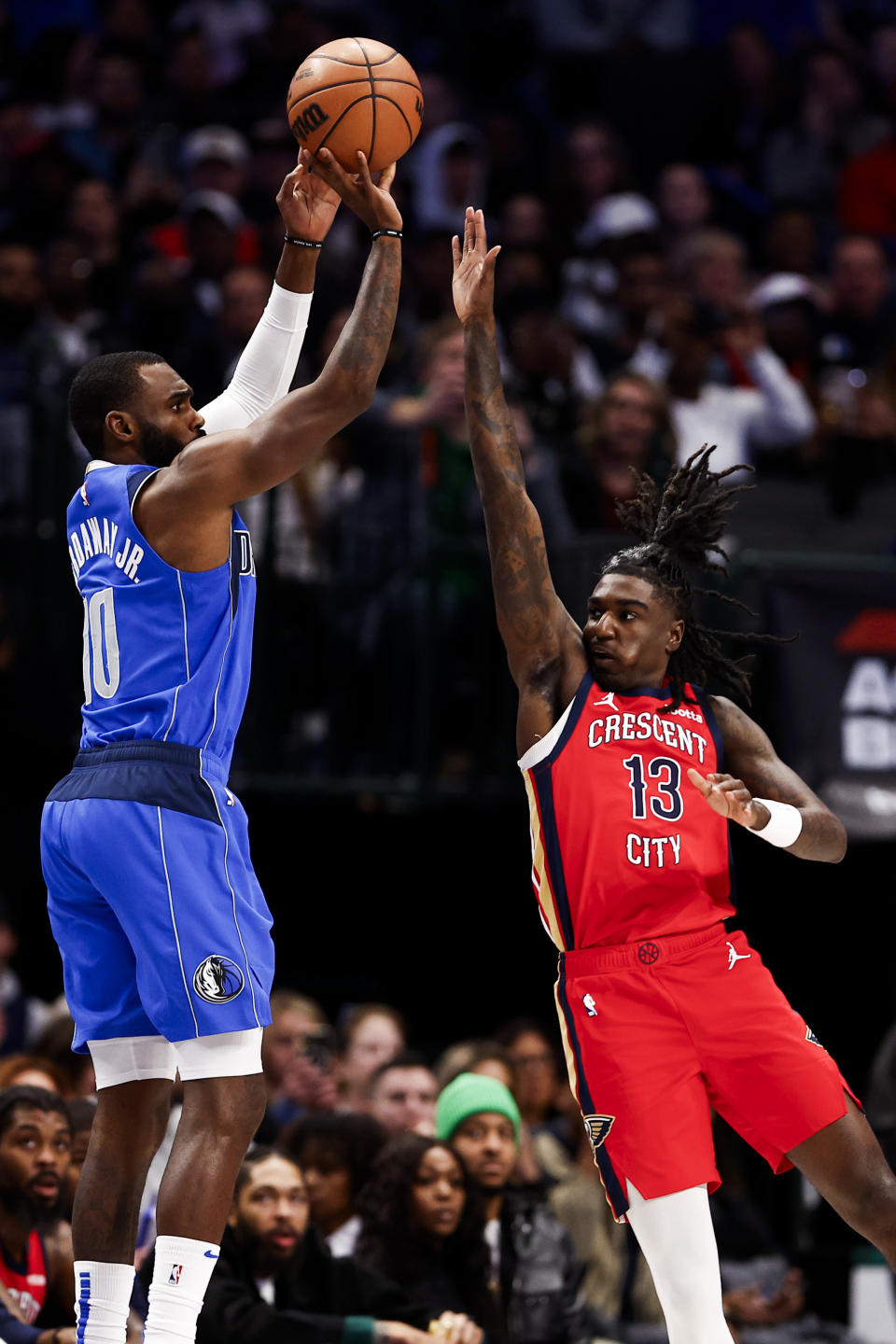 Dallas Mavericks forward Tim Hardaway Jr. (10) shoots as New Orleans Pelicans guard Kira Lewis Jr. (13) defends during the first half of an NBA basketball game Saturday, Jan. 13, 2024, in Dallas. (AP Photo/Brandon Wade)