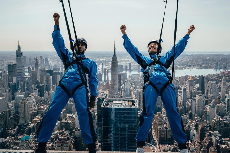 Hanging over the edge of City Climb at the Edge over NYC