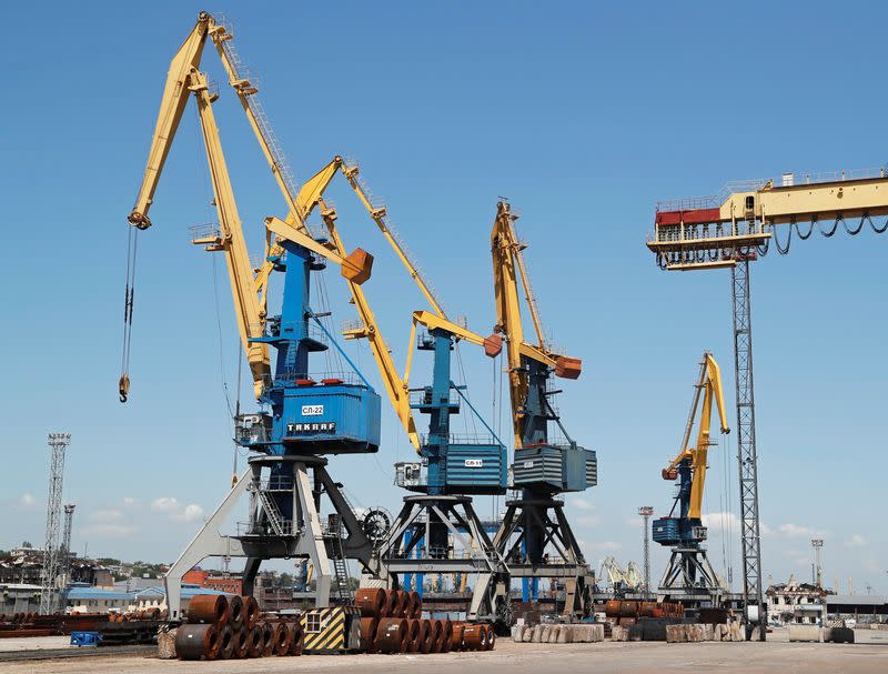 FILE PHOTO: A cargo ship is loaded with steel rolls at the Port of Mariupol