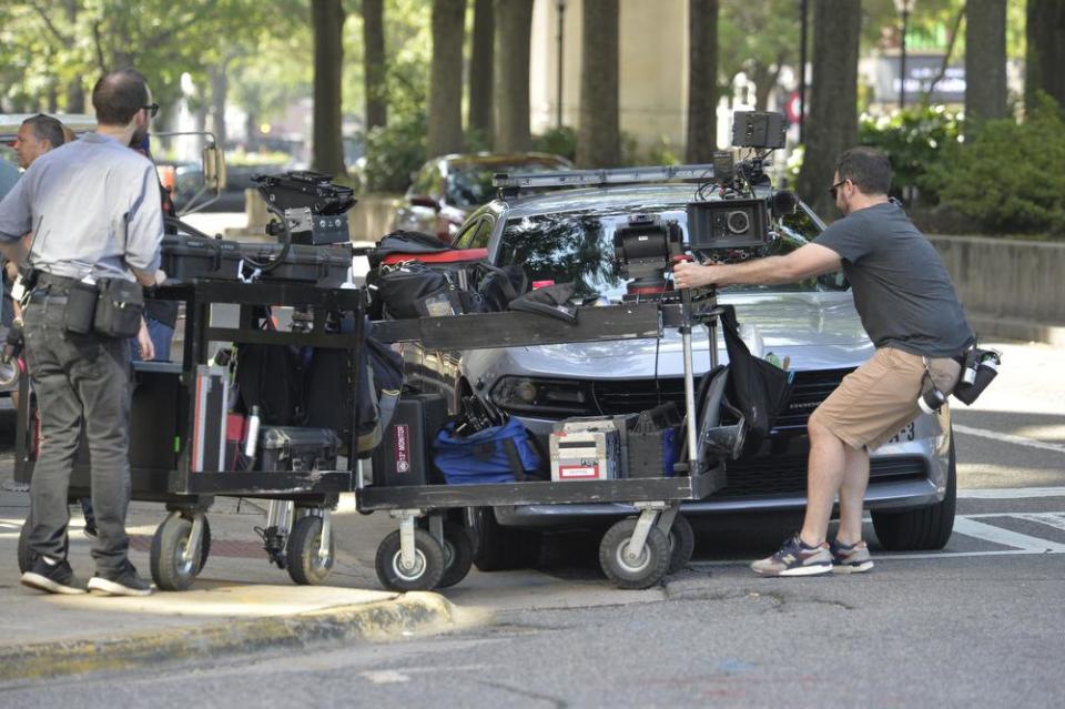 Workers prepare for the filming of the Clint Eastwood movie, The Mule, along Broad Street on Wednesday morning, June 6, 2018, in downtown Augusta, Ga.