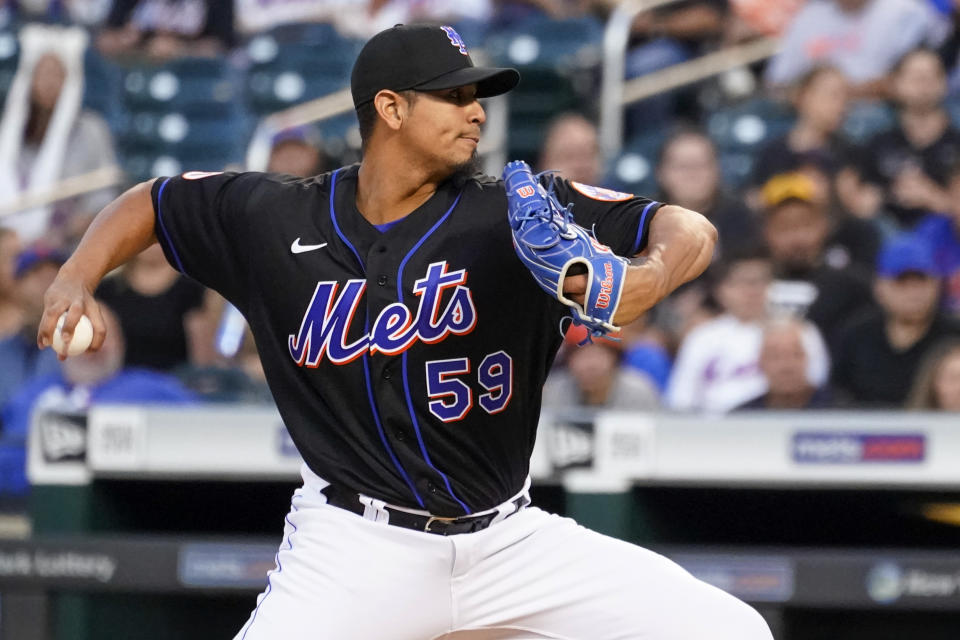 New York Mets pitcher Carlos Carrasco winds up during the second inning of the team's baseball game against the Cincinnati Reds, Friday, July 30, 2021, in New York. (AP Photo/Mary Altaffer)