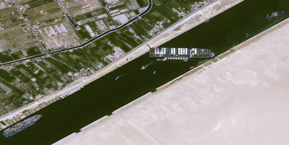 This satellite image from Cnes2021, Distribution Airbus DS, shows the cargo ship MV Ever Given stuck in the Suez Canal near Suez, Egypt, Thursday, March 25, 2021. The skyscraper-sized cargo ship wedged across Egypt's Suez Canal further imperiled global shipping Thursday as at least 150 other vessels needing to pass through the crucial waterway idled waiting for the obstruction to clear, authorities said. (Cnes2021, Distribution Airbus DS via AP)