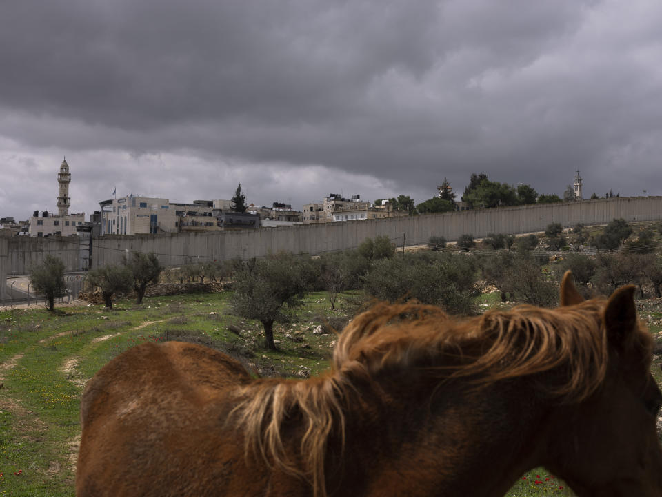 FILE - The West Bank city of Bethlehem behind a section of Israel's separation barrier is seen from Jerusalem, March 4, 2022. (AP Photo/Oded Balilty, File)