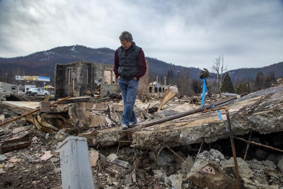 Jonathan Kusel walks across rubble in Greenville.