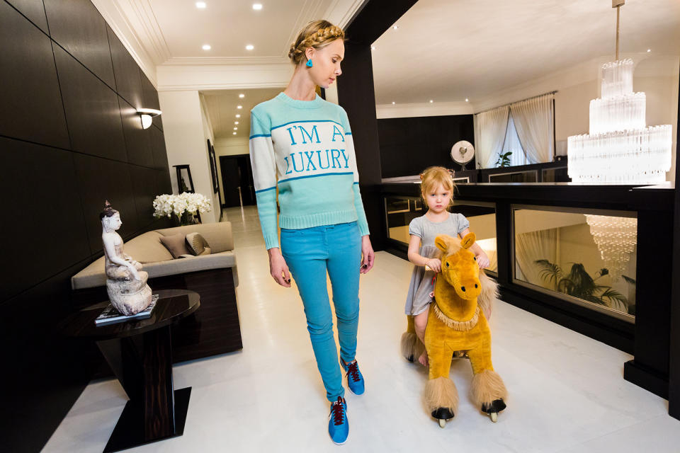 Ilona at home with her daughter, Michelle, 4, in Moscow. Ilona&rsquo;s sweater was produced for her in a custom color by her friend Andrey Artyomov, whose Walk of Shame fashion line is popular among the wives of oligarchs.