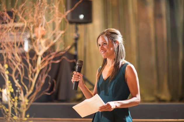 The author giving a toast while rocking her elusive straight hair at her sister's wedding in 2016. (