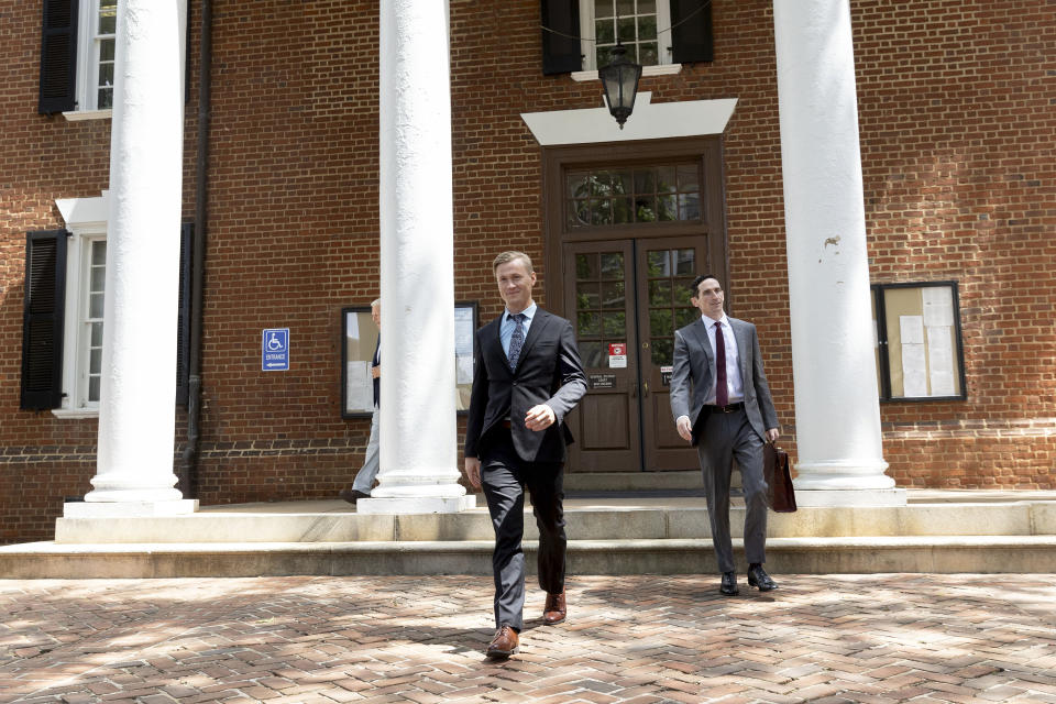 Jacob Joseph Dix and Peter Frazier exit the Albemarle County Circuit Court in Charlottesville, Va., Tuesday, June 4, 2024. The trial of Dix got underway with jury selection. The case will provide the first test of a 2002 Virginia law that makes it a felony to burn something to intimidate and cause fear of injury or death. Lawmakers passed the law after the state Supreme Court ruled that a cross-burning statute used to prosecute Ku Klux Klan members was unconstitutional. (AP Photo/Ryan M. Kelly)