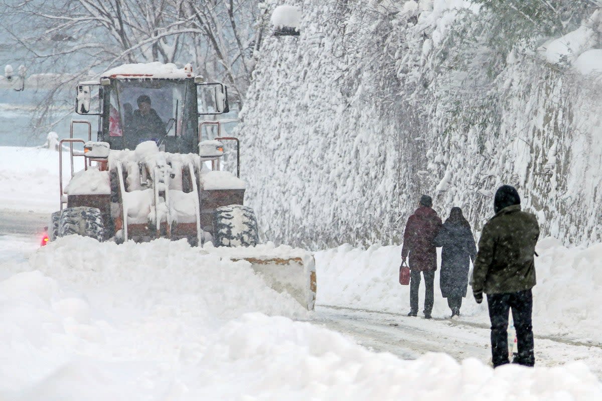 File image: A snowplow clears snow during snowfall in Yantai, in China’s eastern Shandong province   (AFP via Getty Images)