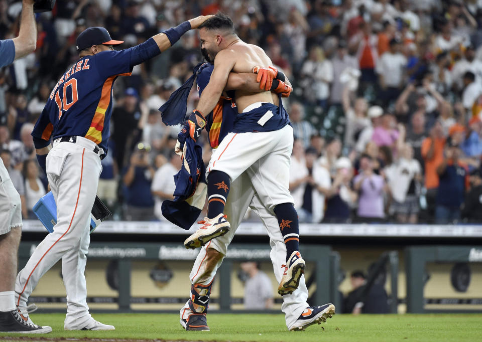 Houston Astros' Jose Altuve, right, celebrates his winning three-run home run with Yuli Gurriel, left, and Michael Brantley during the ninth inning of a baseball game against the New York Yankees, Sunday, July 11, 2021, in Houston. (AP Photo/Eric Christian Smith)